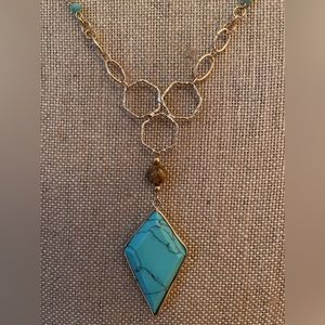 Gold-tone faux turquoise necklace. Honeycomb accent. Lobster clasp. 22” long.